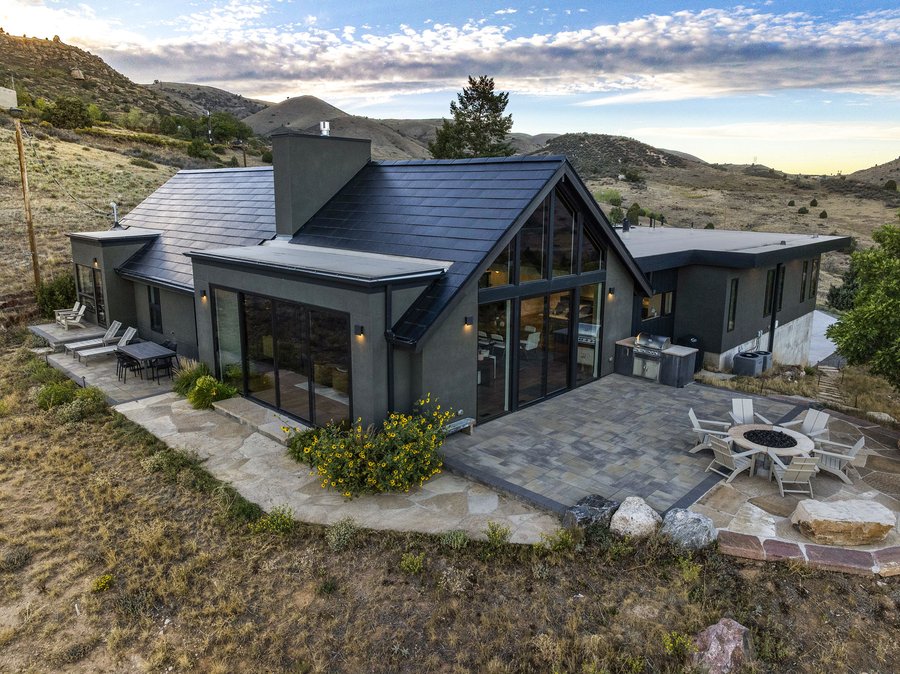 The main house and fire-pit patio at dusk, seen from above