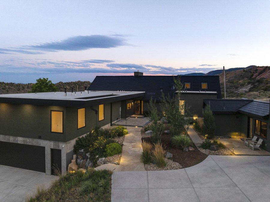 Lit entry path and courtyard at dusk, from above