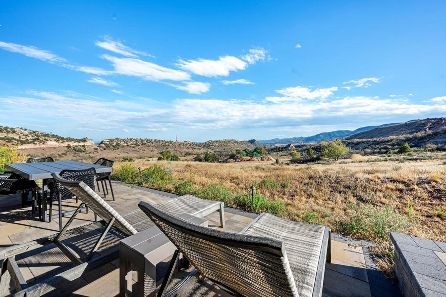 Terrace loungers and dining table looking across the foothills