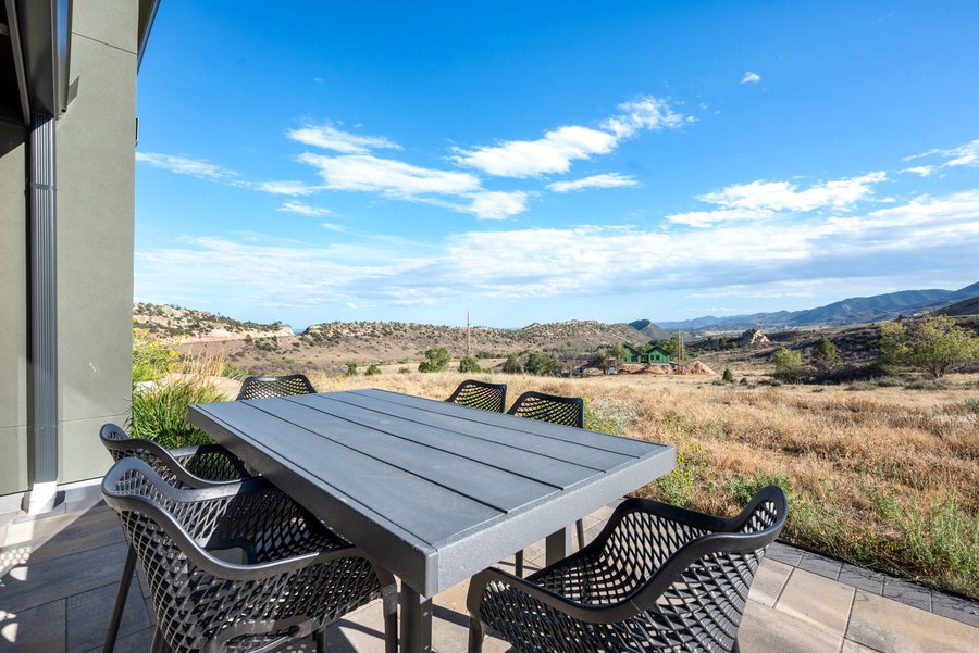 Outdoor dining table on the terrace beneath a wide blue sky