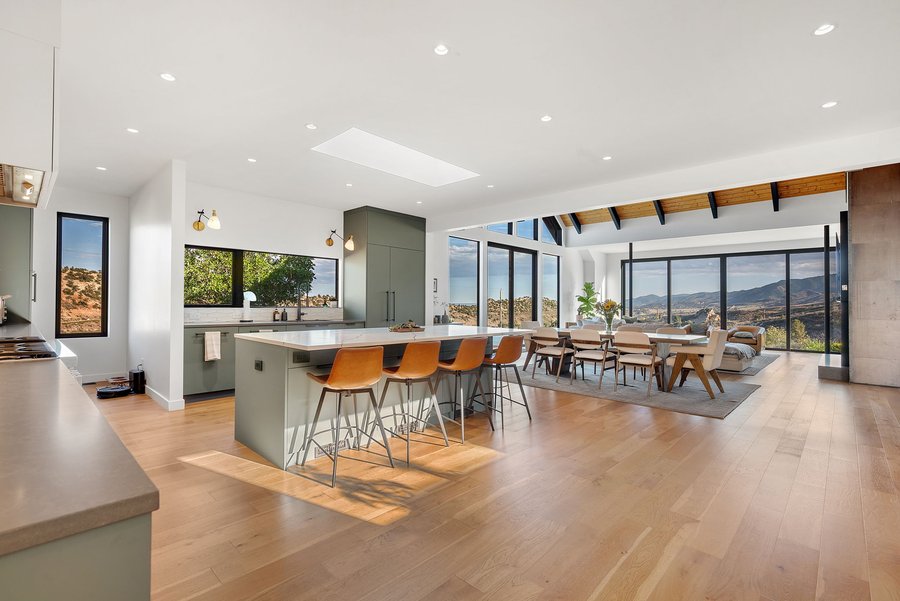 Open kitchen and dining area with counter stools and a view of the hills