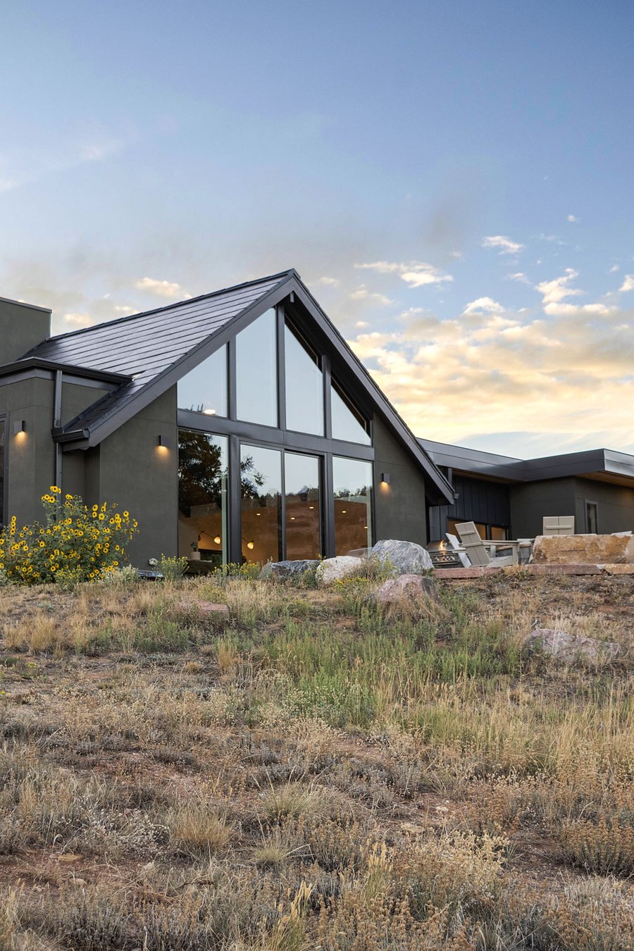 The glass gable at sunset, with the hillside below