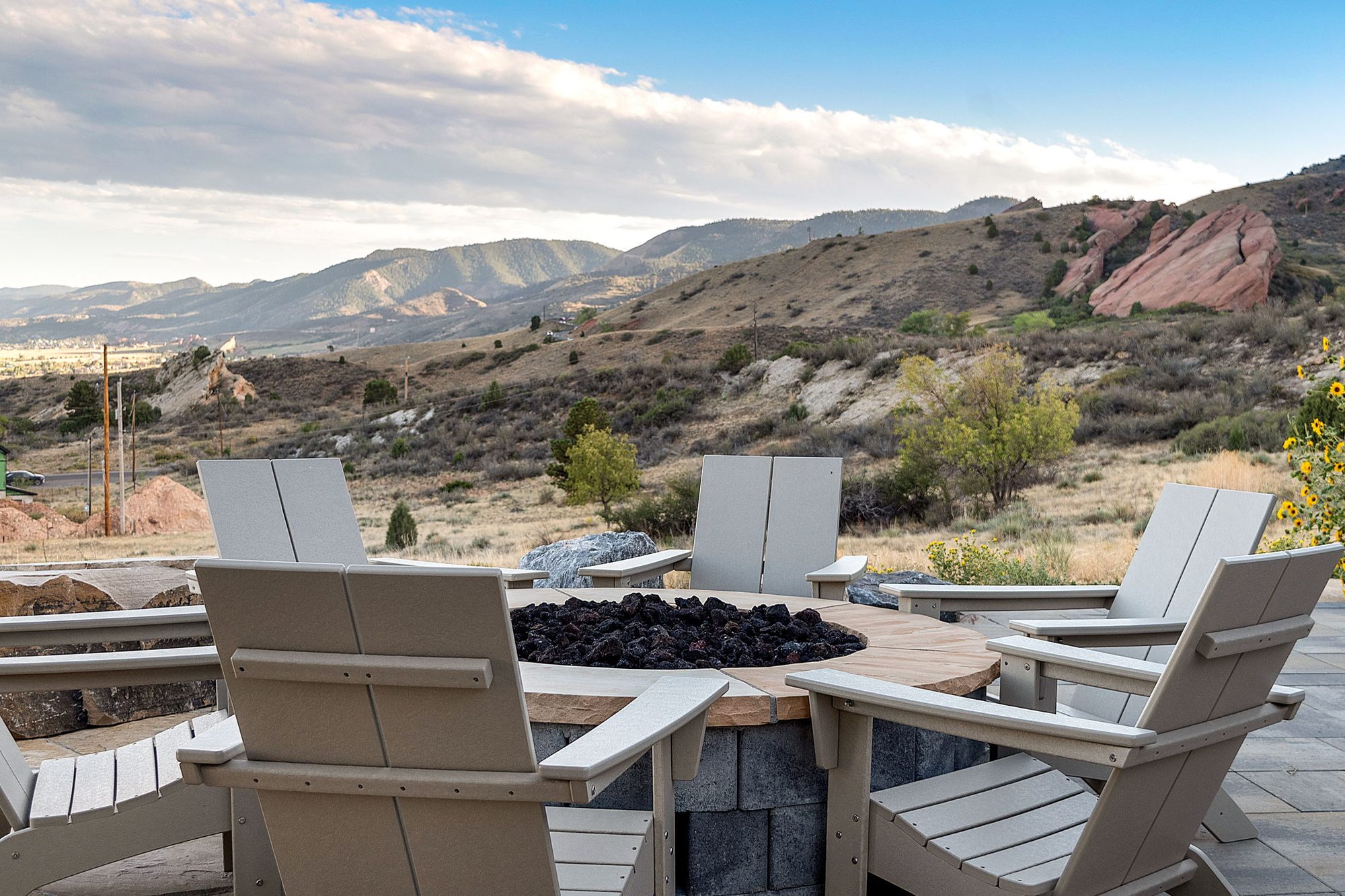 Fire pit and Adirondack chairs facing the foothills