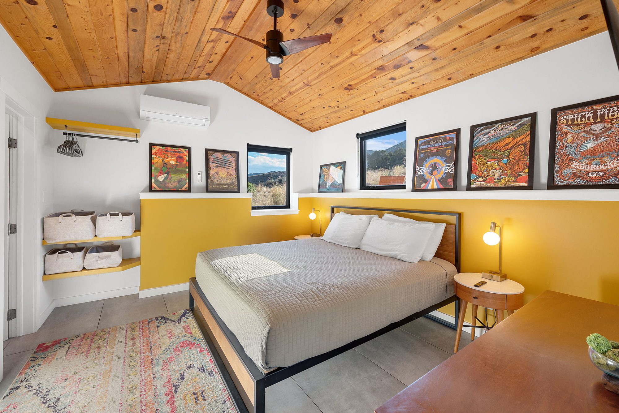 Guesthouse bedroom with a king bed and framed concert posters