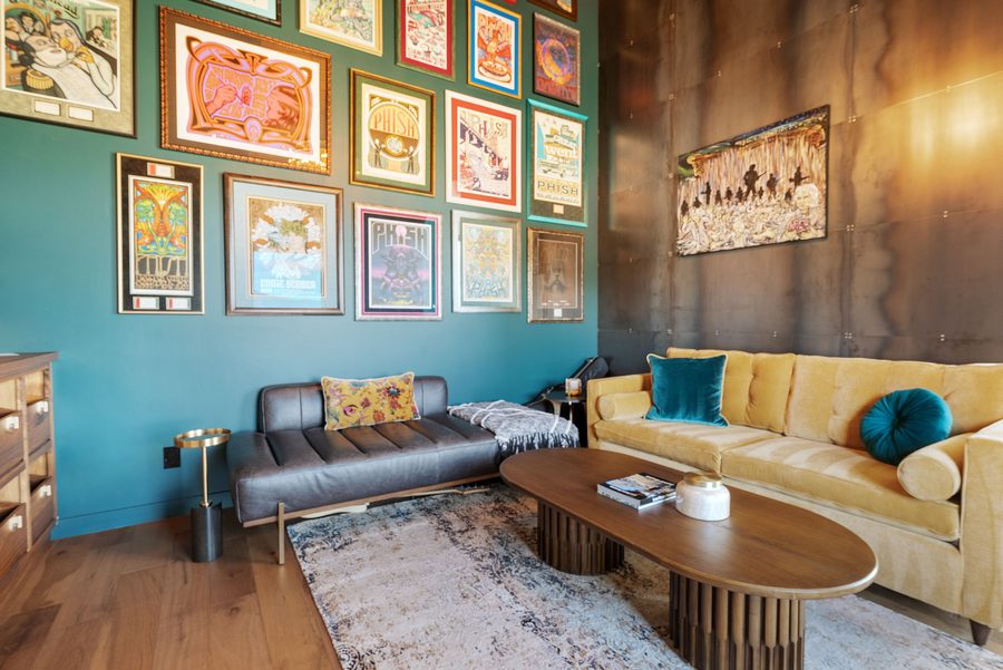 Music Lounge with a wall of framed posters above leather and yellow sofas