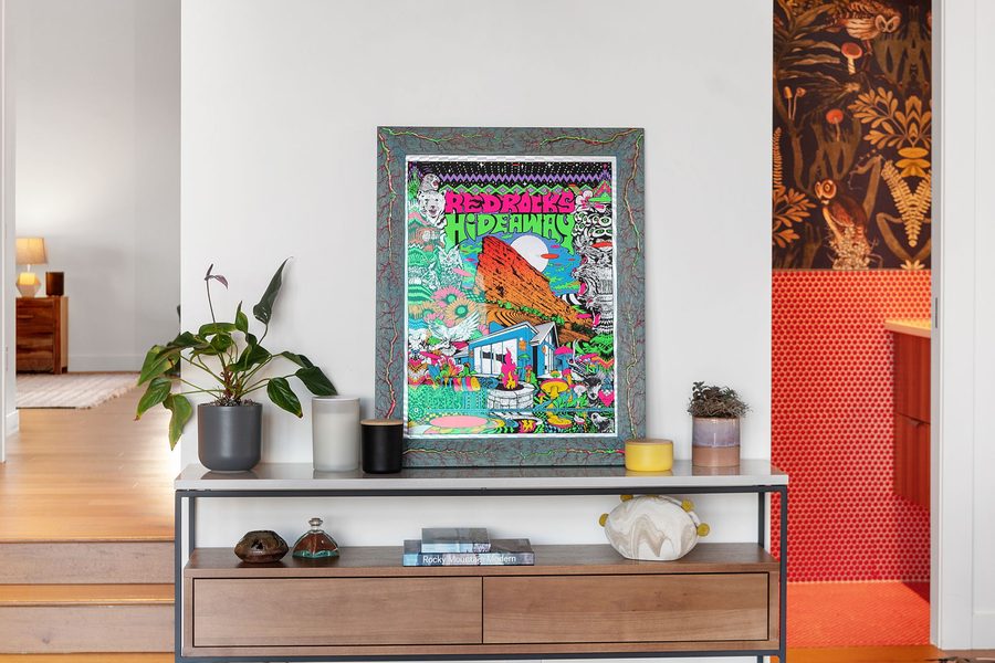 Framed Red Rocks Hideaway poster on a walnut console