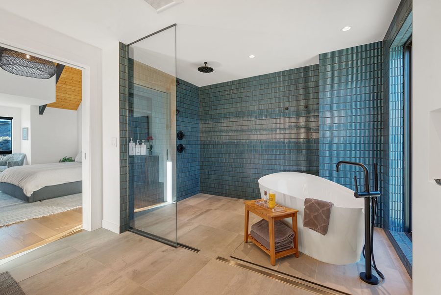 Primary bath with a soaking tub and a walk-in glass shower